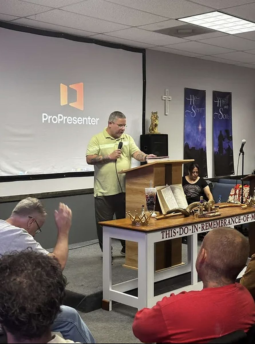 Pastor Eric preaching at the podium
